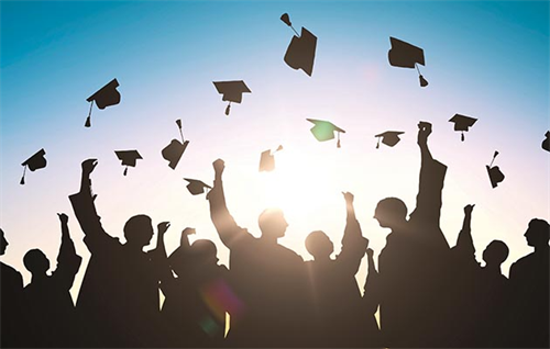 grad caps in air