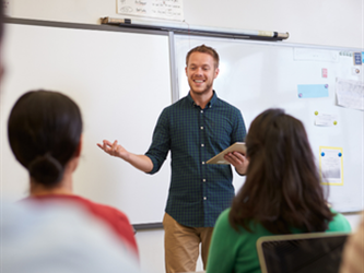 teacher standing in front of a group of students