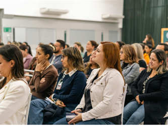 a group of people sitting in chairs at a conference